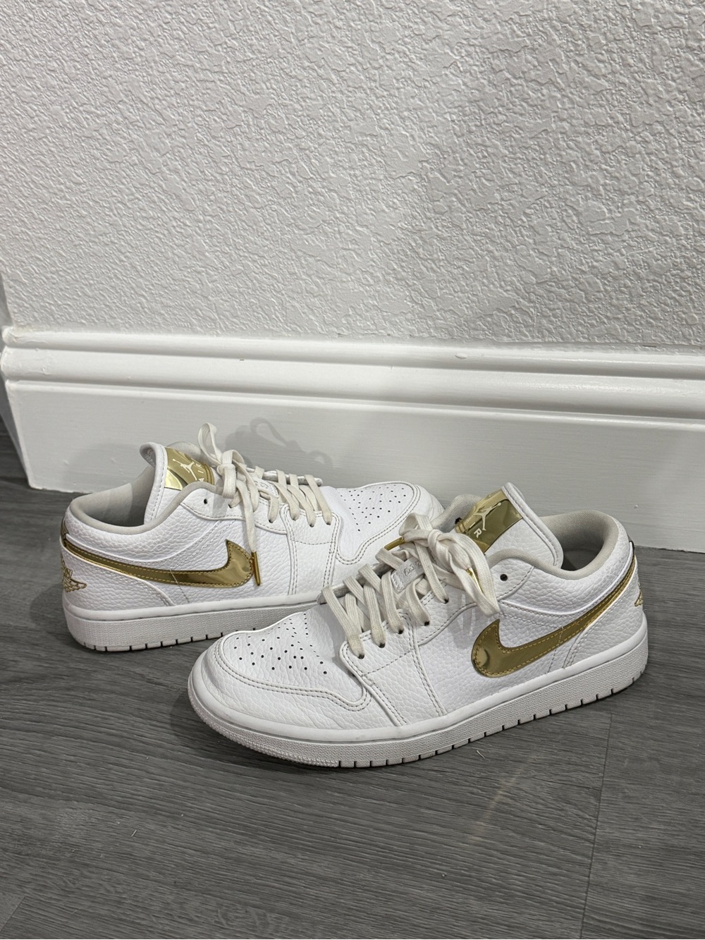Nike Women’s White Sneakers with Metallic Gold Swoosh